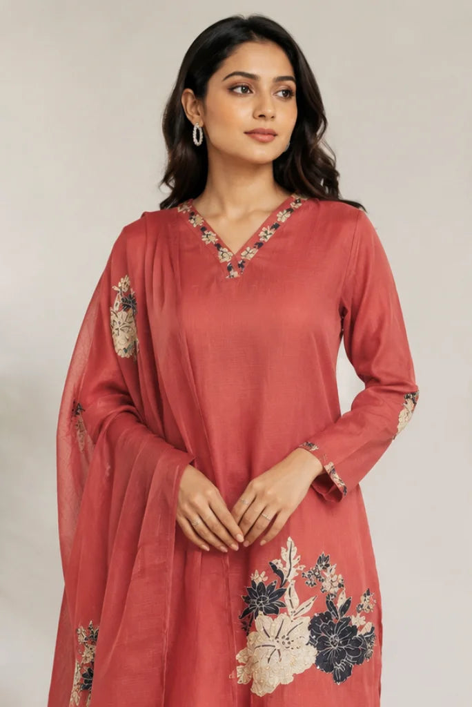 Close-up of V-neck floral border on rust red kurta