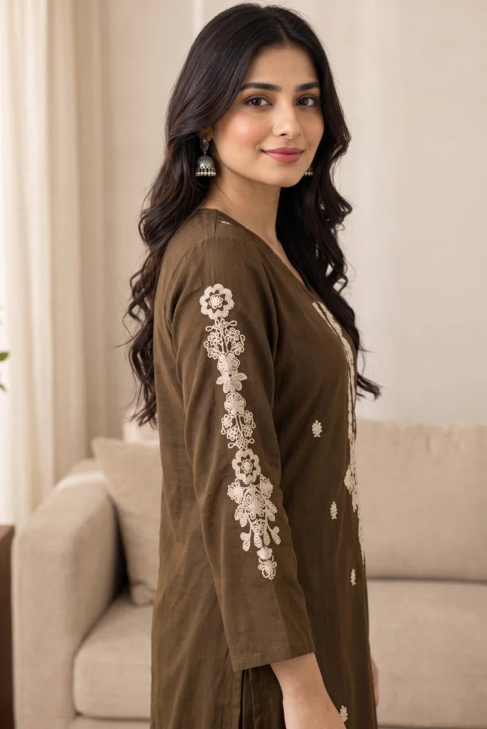 Floral thread work running down the brown kurta sleeve