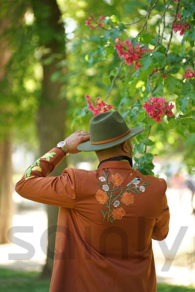 Rust embroidered men’s suit displayed on mannequin
