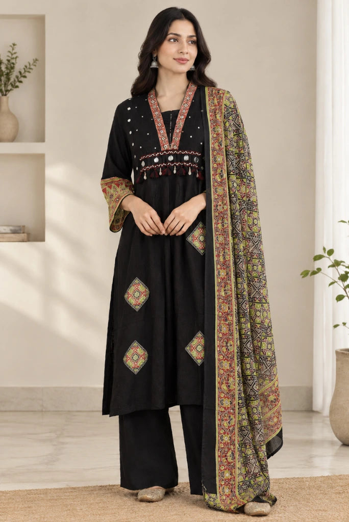 Woman wearing black mirror work kurta palazzo set with printed dupatta, front full look