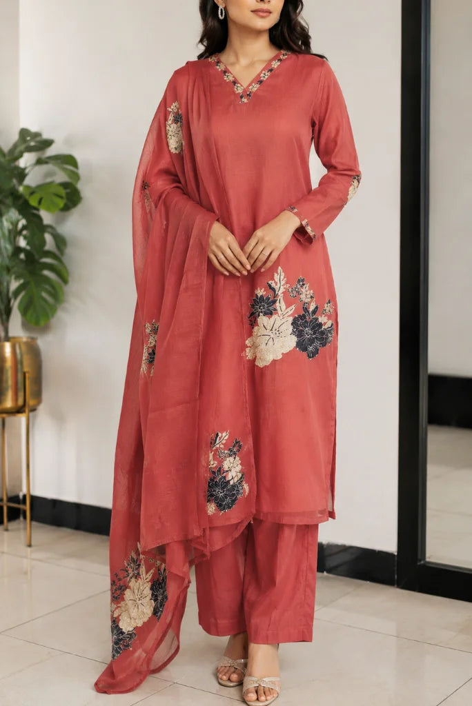 Woman wearing rust red floral patchwork kurta pant set with sheer dupatta, full front look