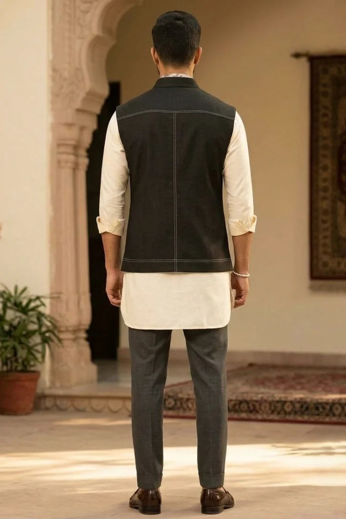 black Nehru jacket over cream kurta with grey trousers Back view